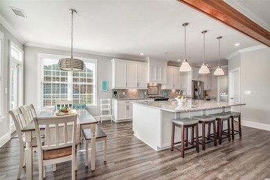 KITCHEN ISLAND AND BREAKFAST AREA OPEN TO BACK POR