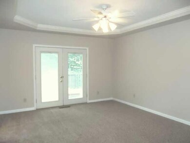 SPACIOUS MASTER BEDROOM WITH TRAY CEILING, WALK-IN CLOSET AND FRENCH DOORS TO HUGE DECK OVERLOOKING PRIVATE BACK YARD.