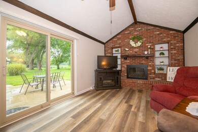 Gorgeous Family Room with Cathedral Beamed Ceiling, fireplace, book shelves.