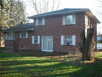 Exterior Back All Brick home with patio door leadi