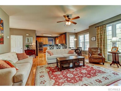 Open family room and kitchen with hardwood floors 