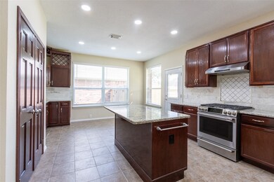 Spacious kitchen featuring granite countertops, mo