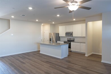 Kitchen with dark wood-type flooring, a center is