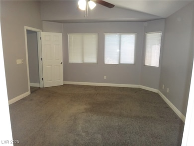 Carpeted empty room with lofted ceiling, ceiling f