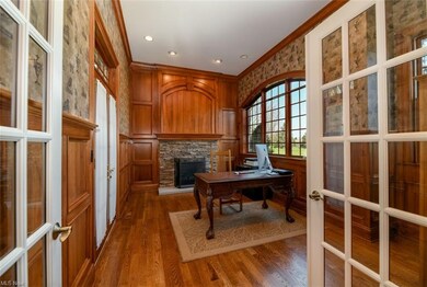 The first floor office area is located off of the foyer and has French doors leading to a private patio and a wood burning fireplace.