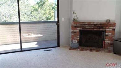 Brick faced fireplace in living room, with exterio