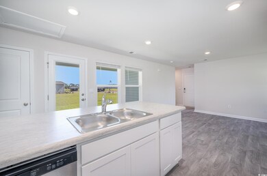 Kitchen with white cabinets, dishwasher, dark hard