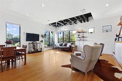 Original hardwood flooring complements the neutral, modern aesthetic