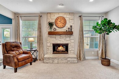 Gorgeous floor to ceiling stone fireplace with windows to the large backyard.