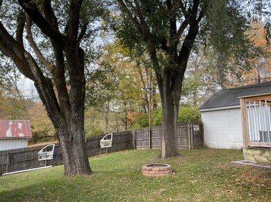 Beautiful fenced in back yard with a fire pit!
