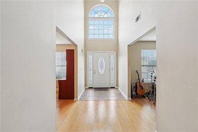 Foyer entrance featuring visible vents, baseboards