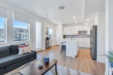 Living room with light wood-style floors and recessed lighting