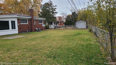 Fenced backyard with an outbuilding