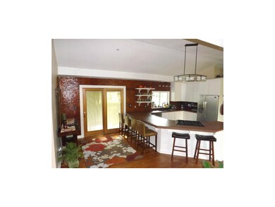 Gorgeous Mosaic Tile wall  with walk out Patio door to your Beautiful Covered Porch