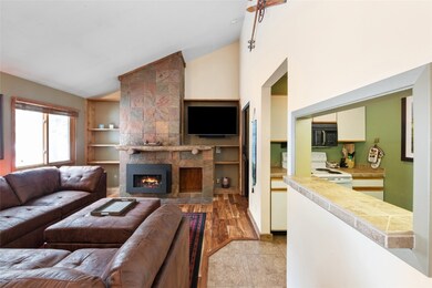 Living room with a gas fireplace, and vaulted ceil