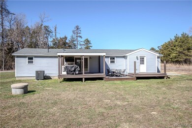 Rear view of house with central AC unit, a wooden