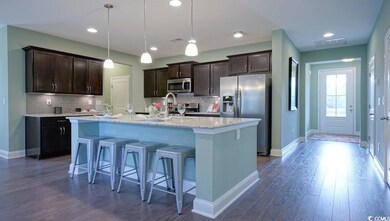 Kitchen with appliances with stainless steel finishes, dark brown cabinets, baseboards, and recessed lighting