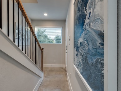 Entryway with concrete floors and stairway