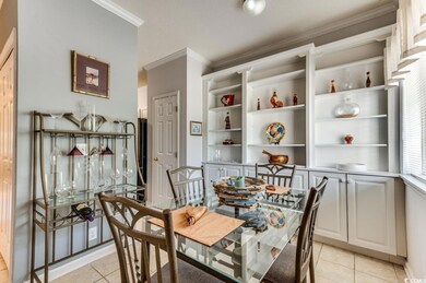 Dining room with ornamental molding and light tile