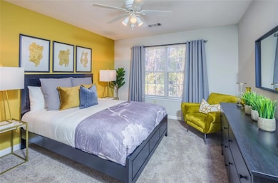 Carpeted bedroom with ceiling fan