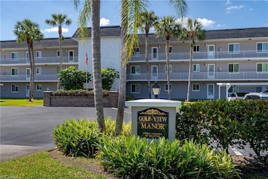 View of building exterior featuring covered parkin