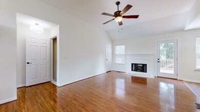 Bright, open living room with vaulted ceiling & tons of natural light.