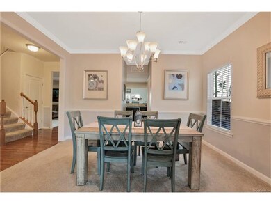 Dining Room with crown molding and chair rail