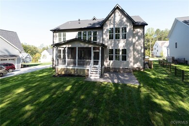 Rear view of house featuring a garage, a sunroom,