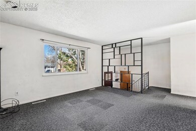 Empty room with baseboards, a textured ceiling, da