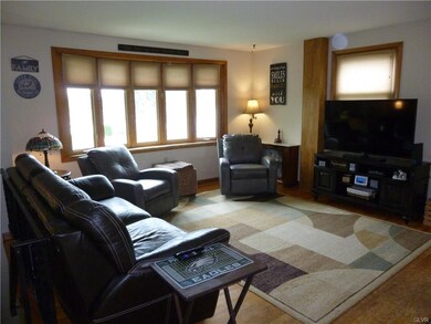 Living Room With Hardwood Floors & Bay Window
