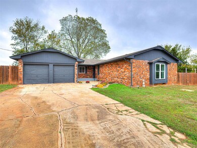 View of front facade with concrete driveway, brick siding, and an attached garage