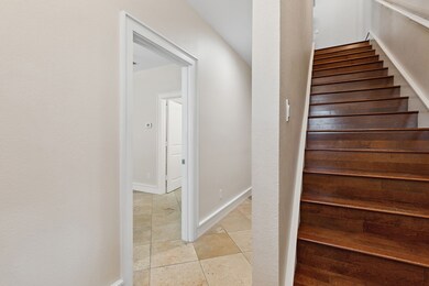 Stairway featuring tile patterned flooring and baseboards