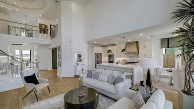 Living room with stairs, light wood-style floorin