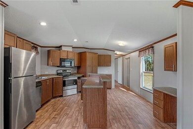 large kitchen with island and desk area