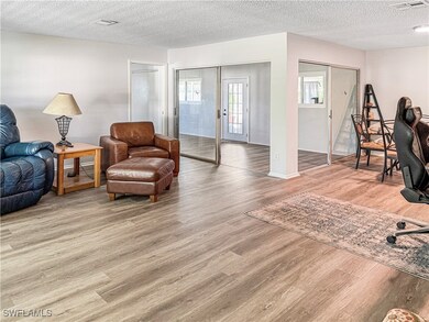 Living area with wood finished floors, a textured