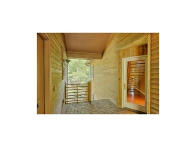 Breezeway entry with garage to the left, backyard 