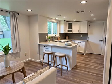 Kitchen with a peninsula, wood finished floors, w