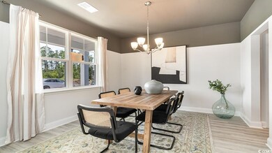 Dining area featuring a chandelier and light hardw
