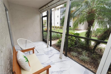 Sunroom featuring a textured wall and marble finish floors