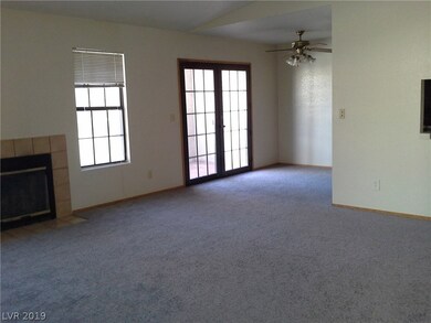 Living room with wood burning fireplace. Dining ar