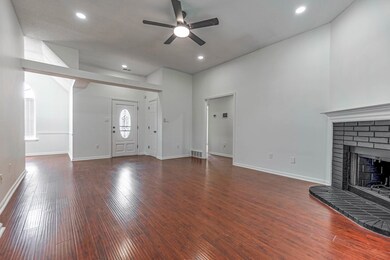 Unfurnished living room with ceiling fan, a firepl