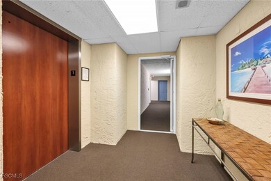 Elevator & view of front door, down the hall.