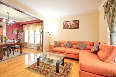 Living room with an inviting chandelier, ornamenta