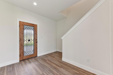 Entryway featuring wood finished floors, baseboar