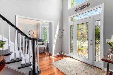 Foyer entrance featuring crown molding, baseboards