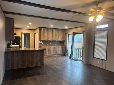 View from front entry door into living, dining, ki