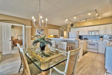 Dining room with a textured ceiling, an inviting c