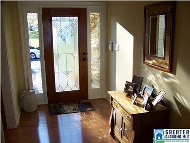 Entrance foyer has pretty glass front door and amp