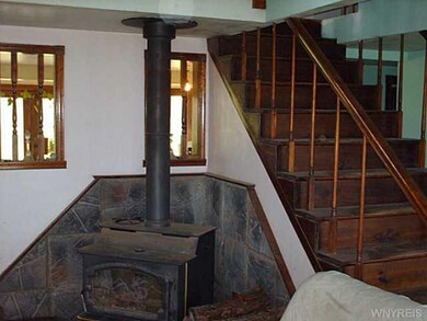 Living Room wood stove and stairway to loft