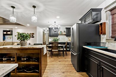 Kitchen featuring light wood-type flooring, tastef